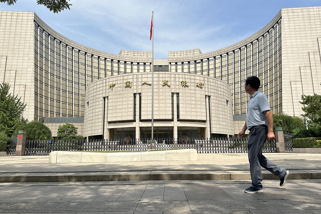 A man walks by the People's Bank of China in Beijing. Photo: VCG
