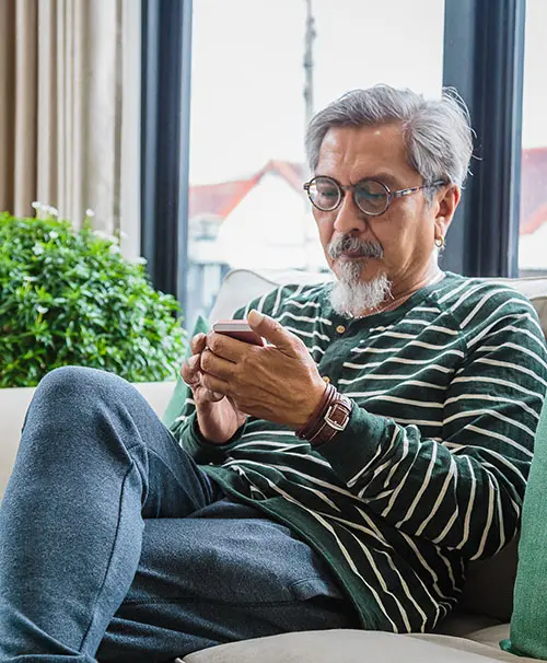 Man sat down looking at phone