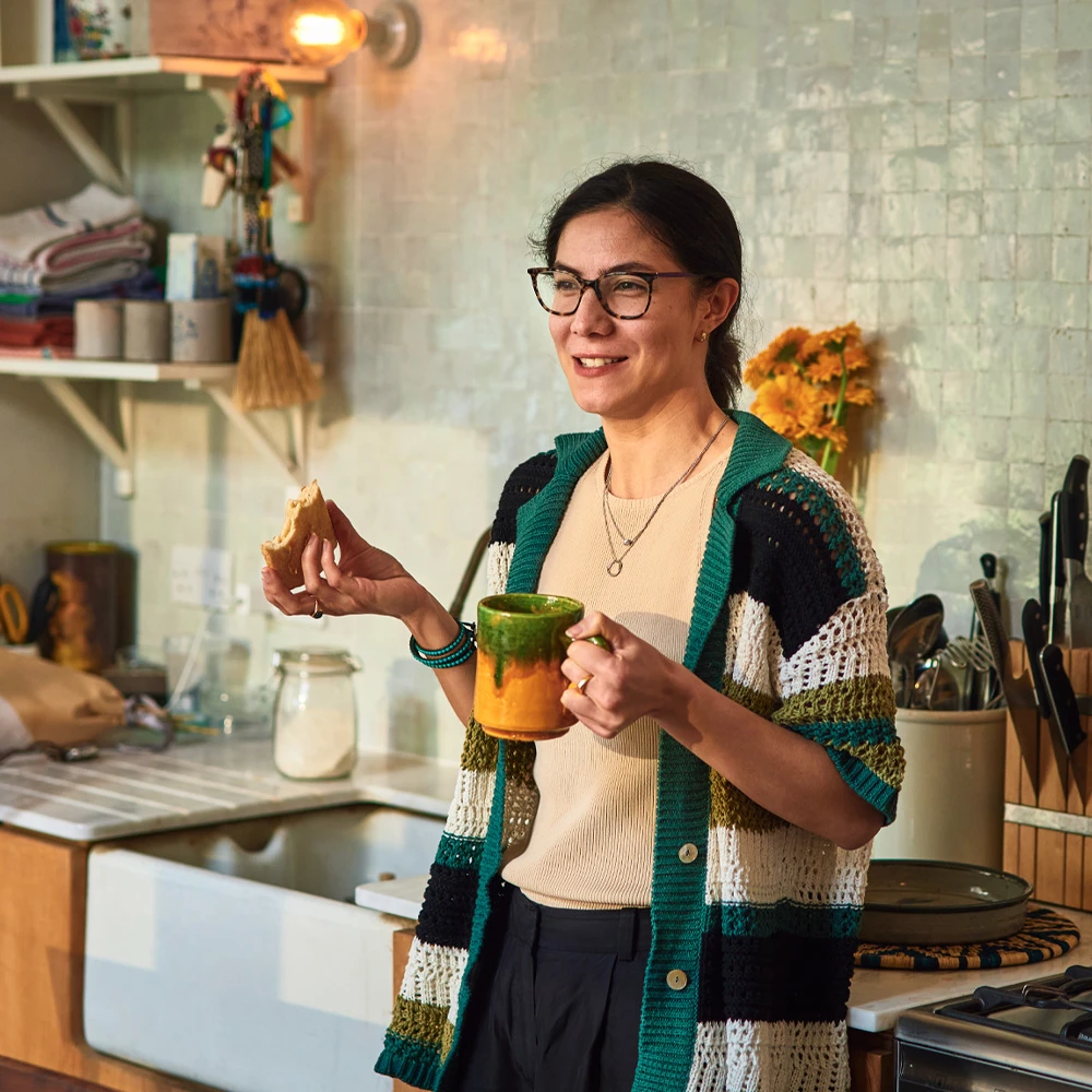 Young woman with dark hair looking at laptop